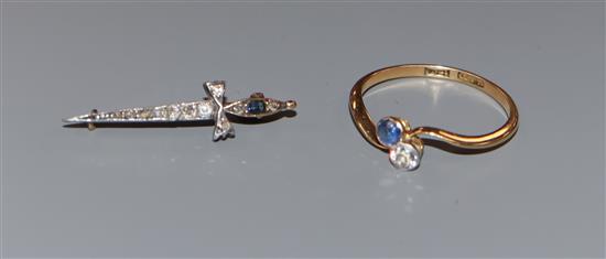 An early 20th century 18ct, two stone sapphire and diamond crossover ring and a similar sapphire and diamond set dagger brooch